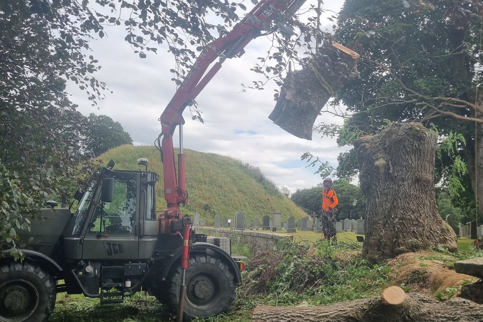 Crane handling large timber sections on site