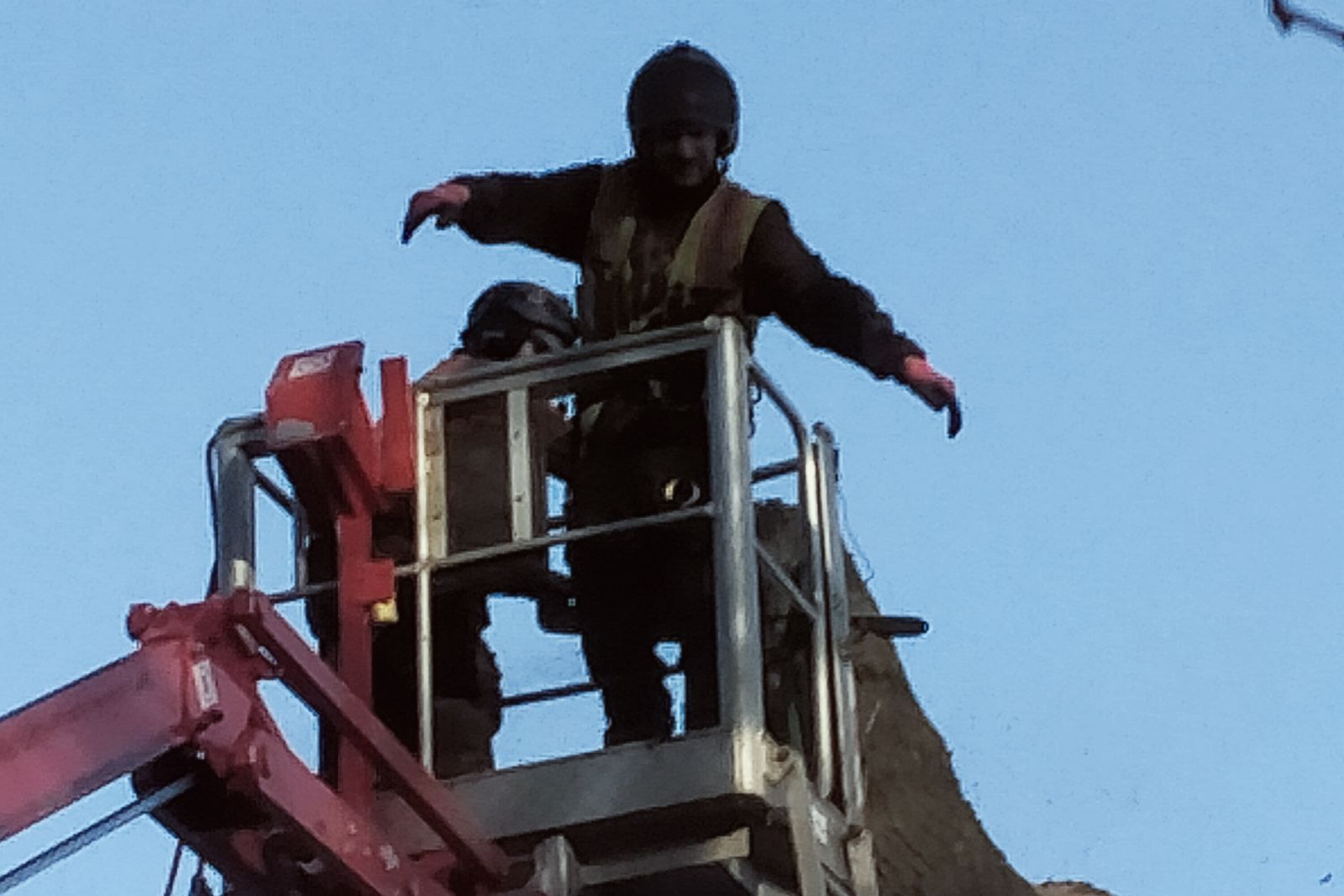 Operator working from the basket at the top of a cut trunk