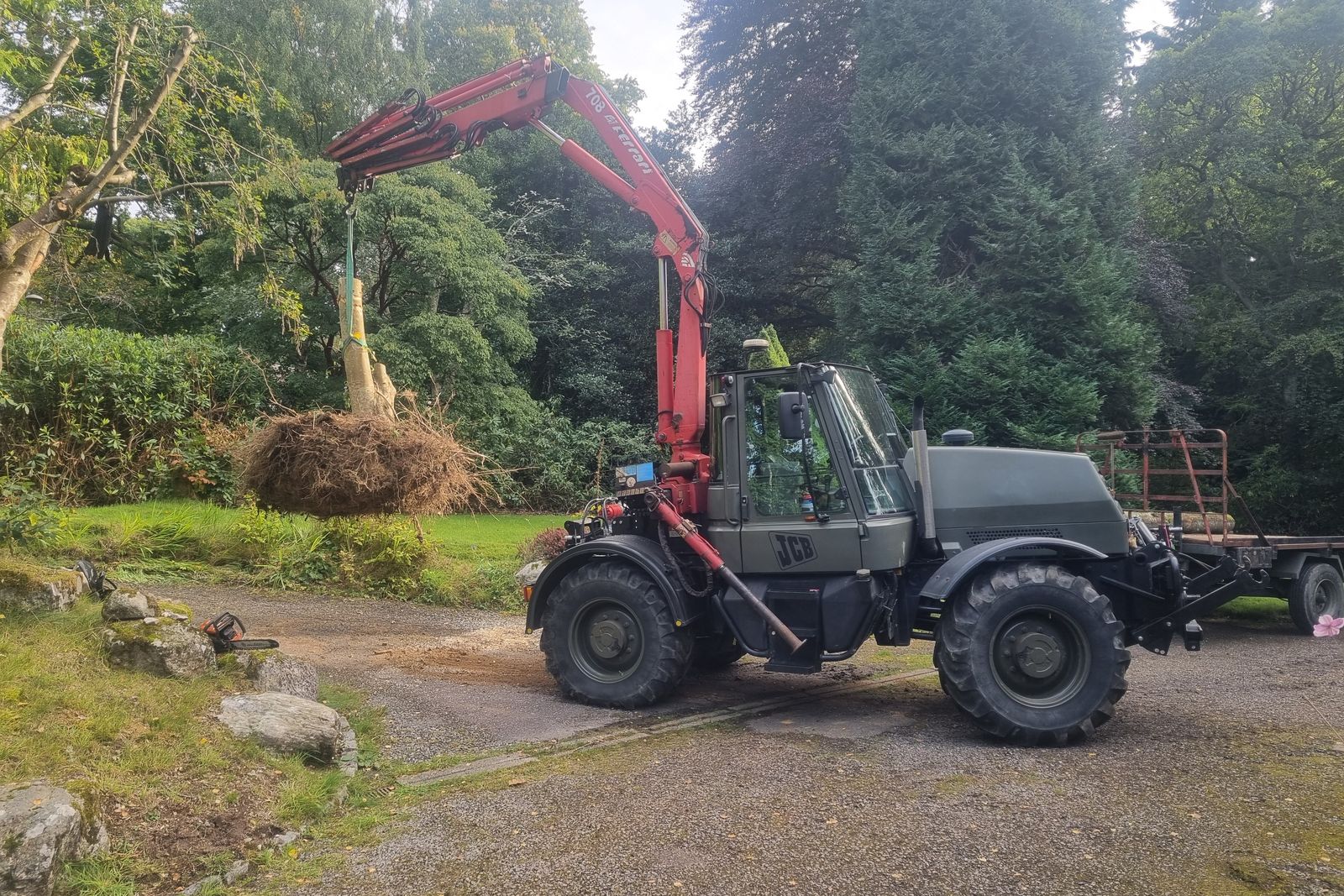 Unimog and crane clearing brash after stump work