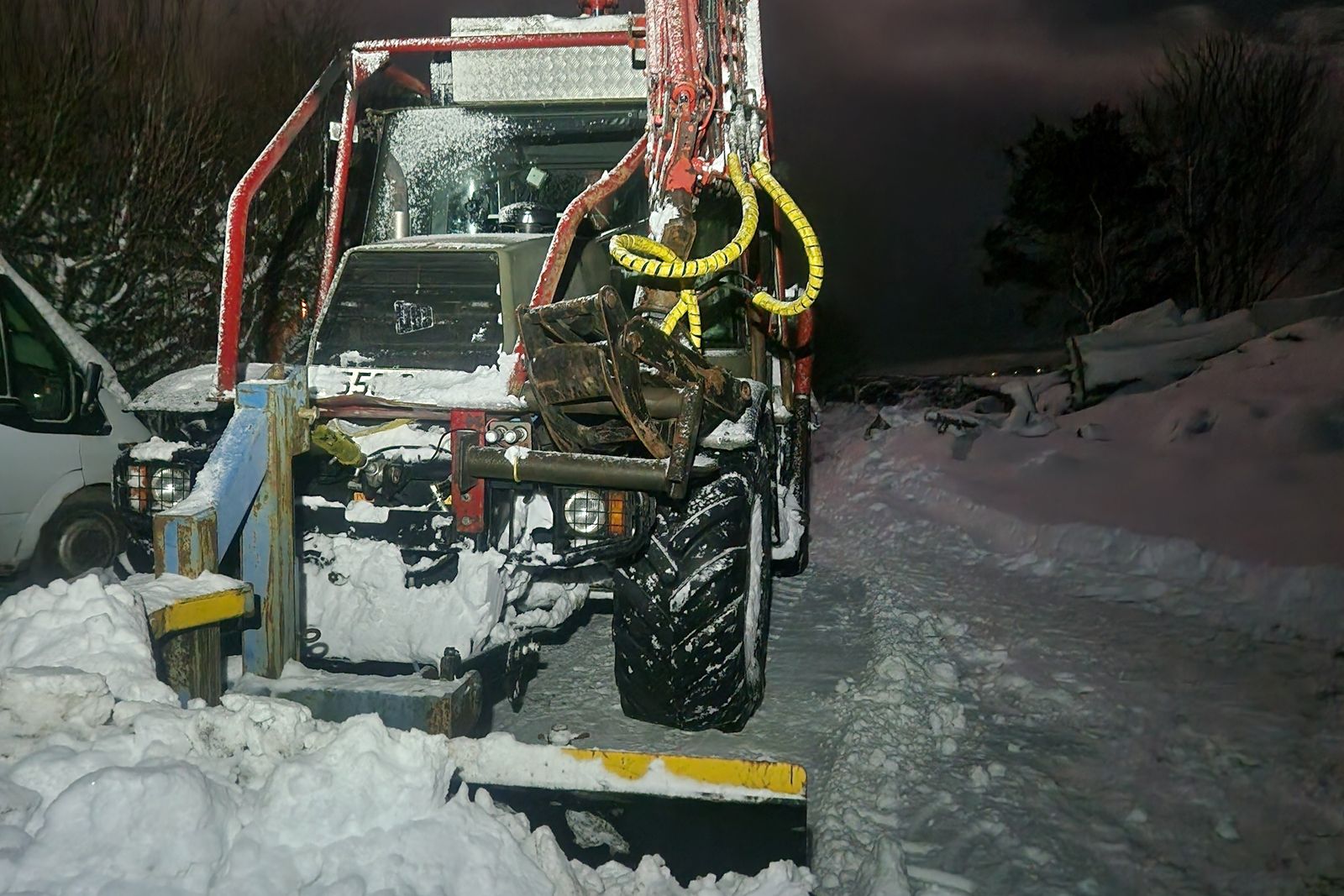 Plough working through fresh snow